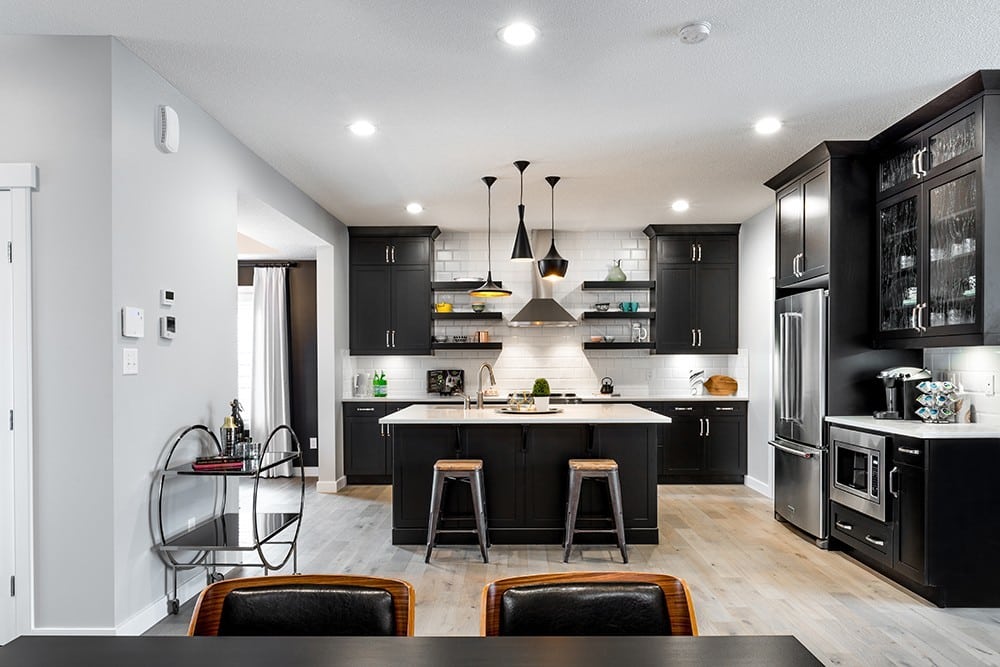 black cupboards and white counters in kitchen