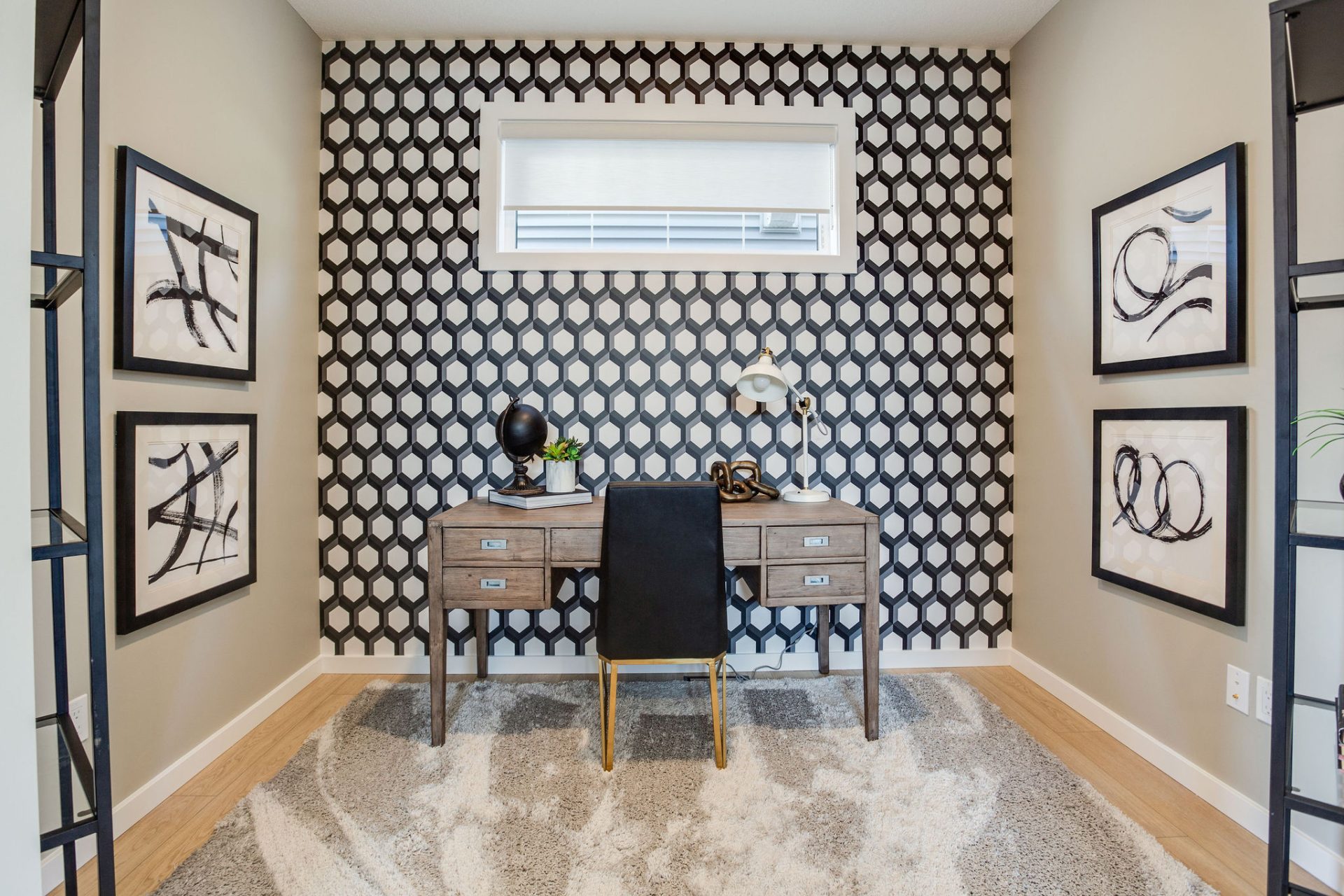 A showhome office area with desk and 3D honeycomb wallpaper