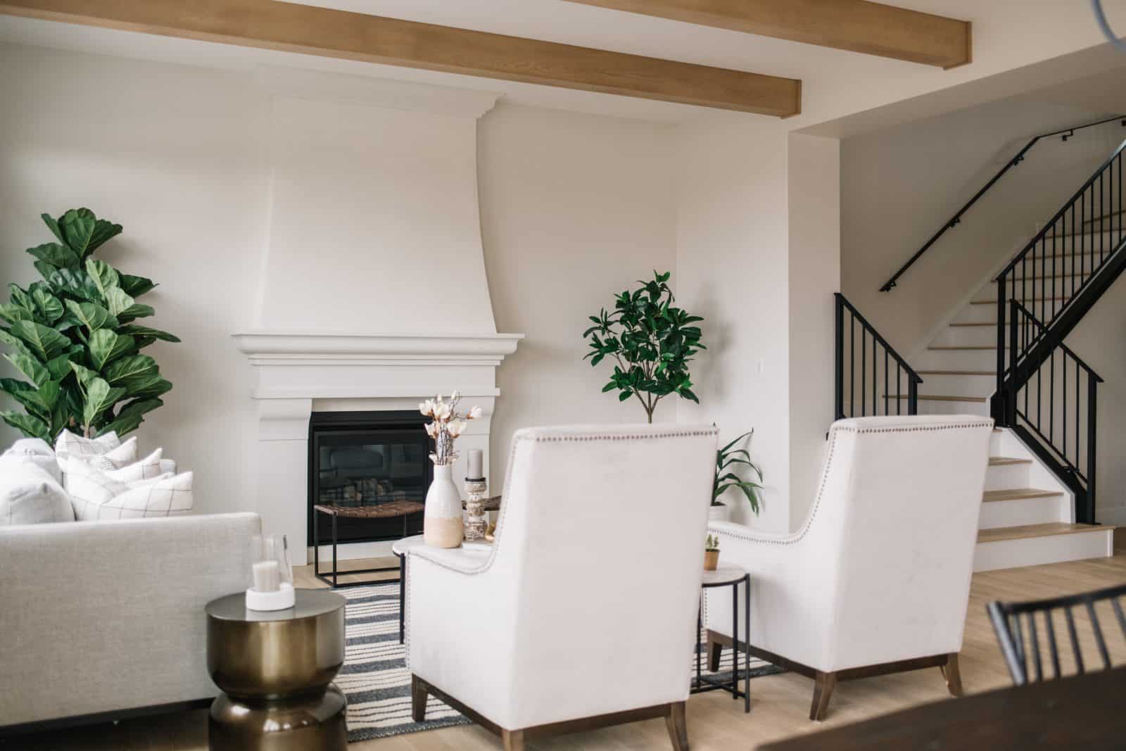 family room with fireplace and white tall back chairs