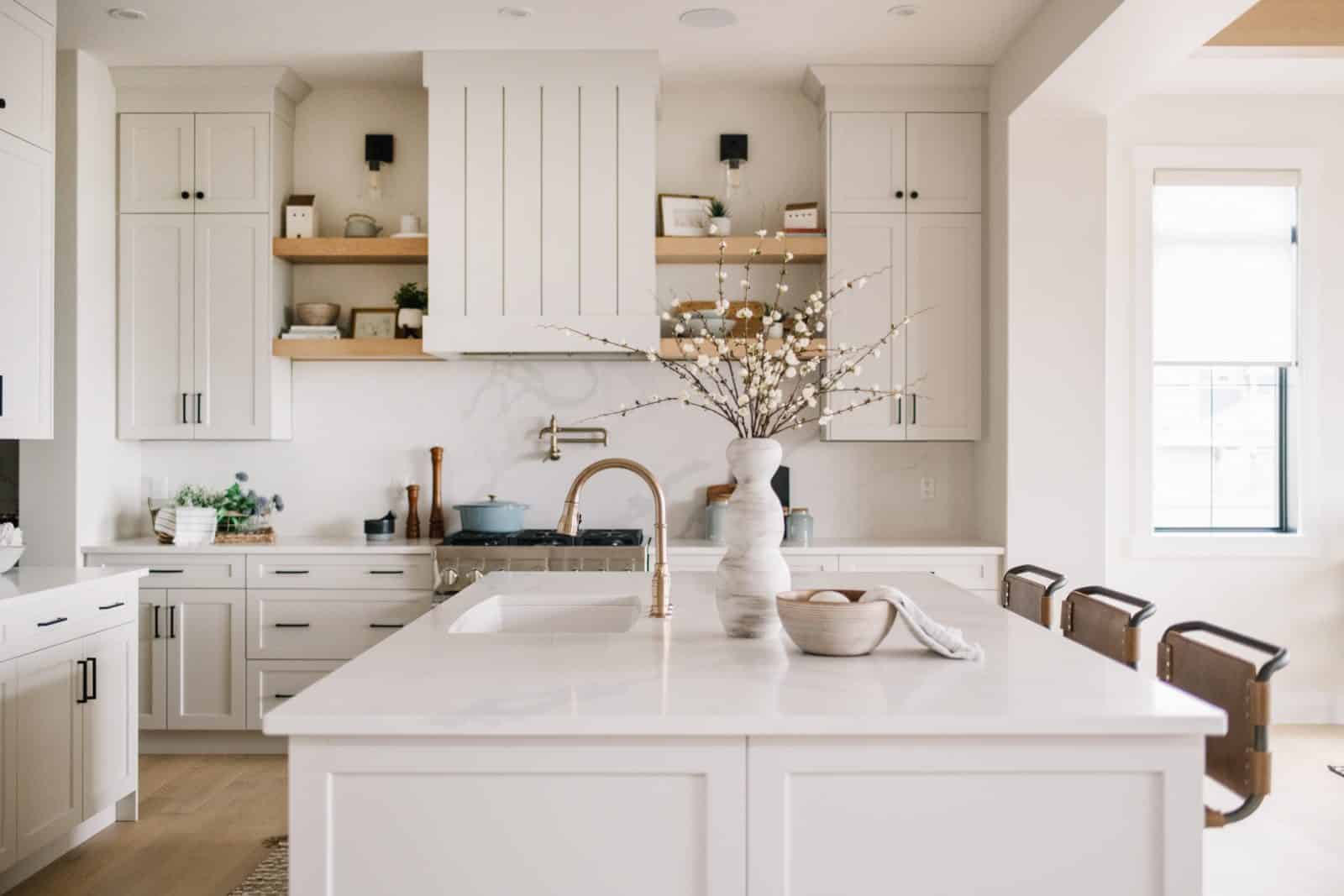 white kitchen counters and cupboards with light hardwood floors
