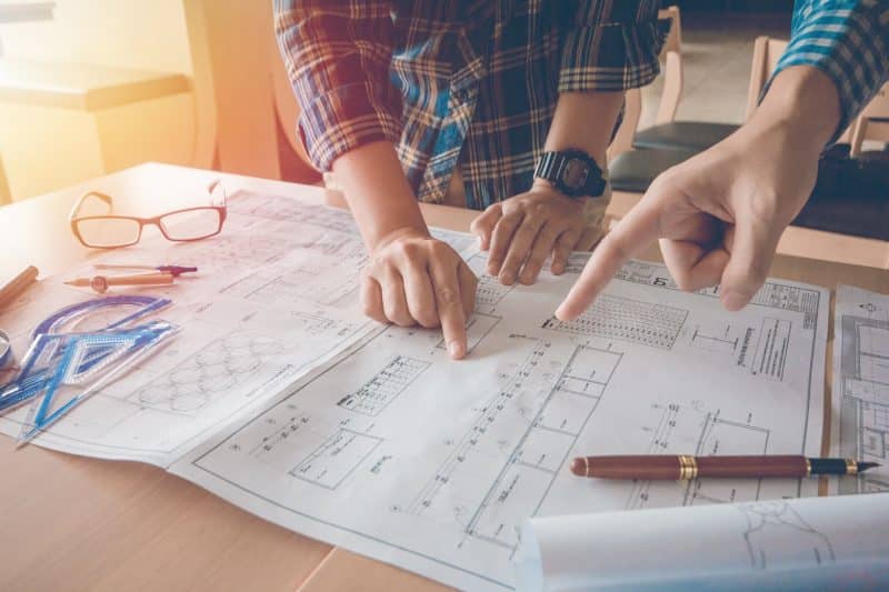 People review the blueprints of a new construction home.