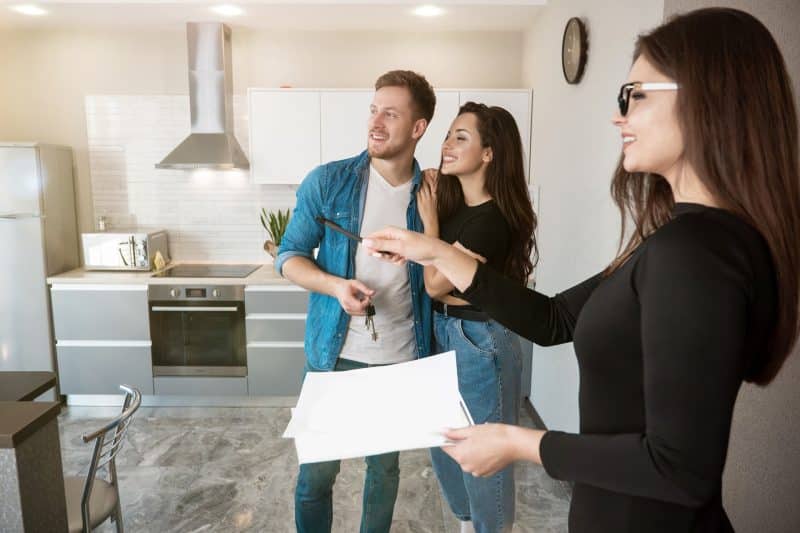 A couple visits a design centre and is shown options by an interior designer.