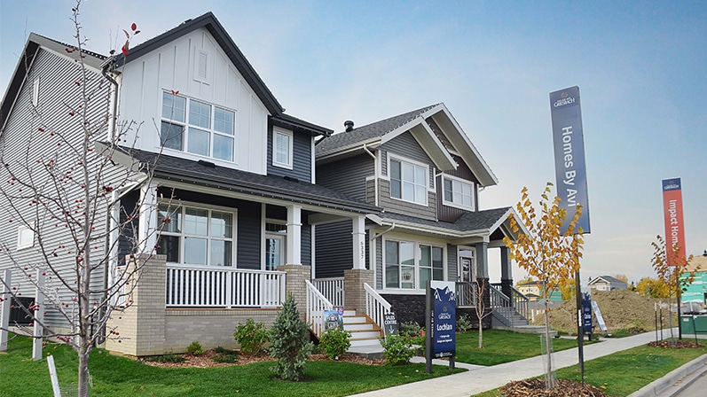 Two detached garage laned homes. Both are in a craftsman architectural style with front porches and pointed rooftops.