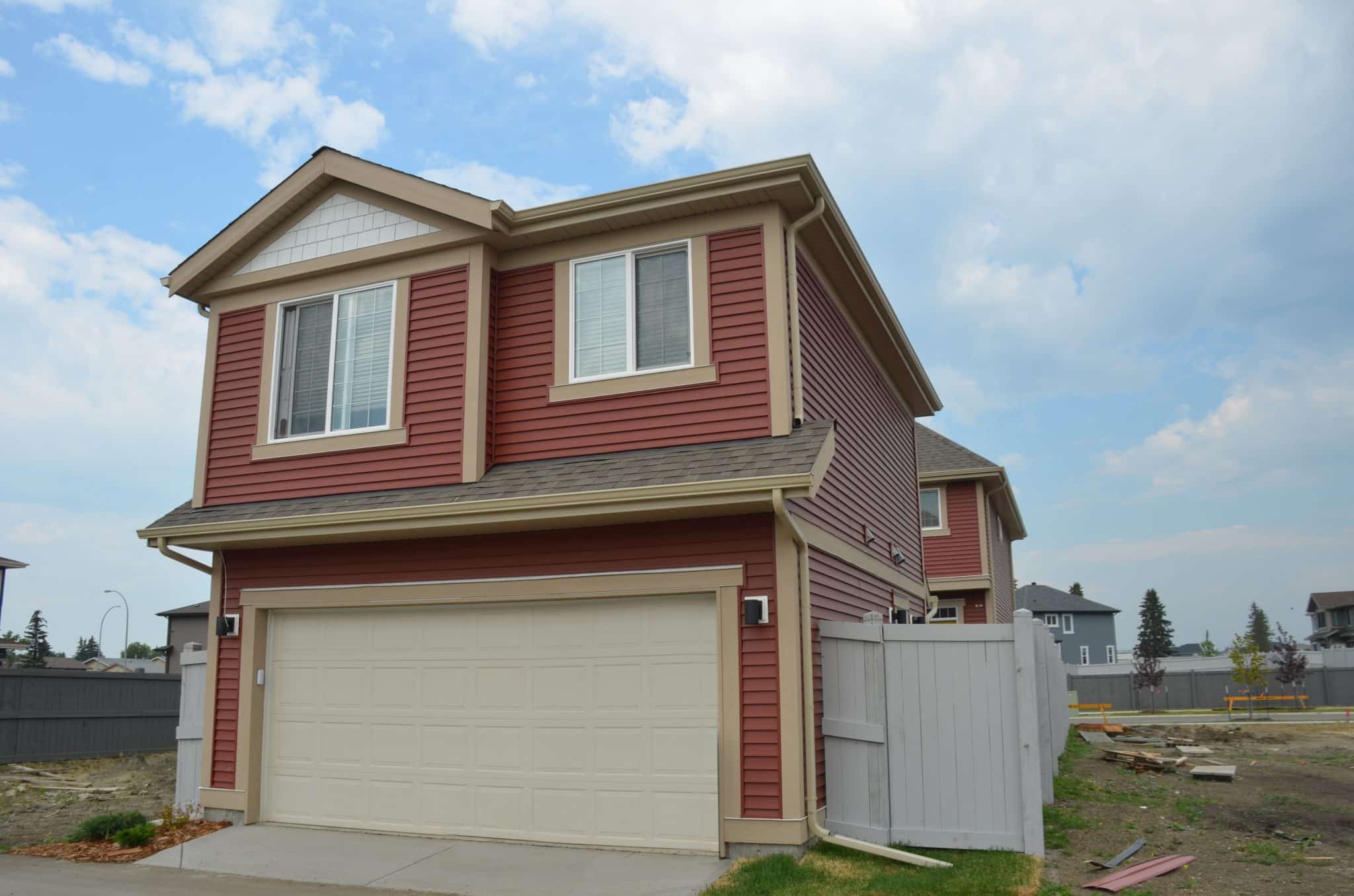 Red house with garden suite on top of garage