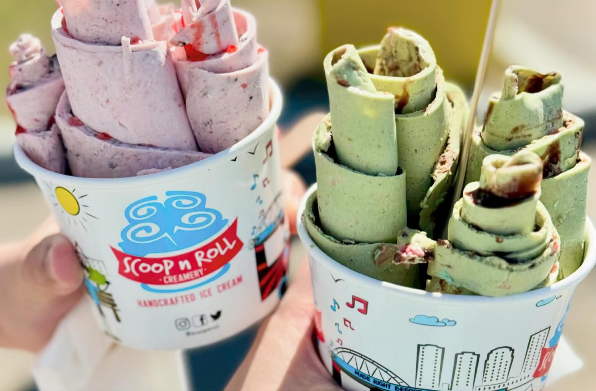 Two bowls of rolled ice cream side by side, strawberry and matcha with colourful mix ins. Deux coupes de crème glacée roulée côte à côte, à la fraise et au matcha, avec des mélanges colorés.